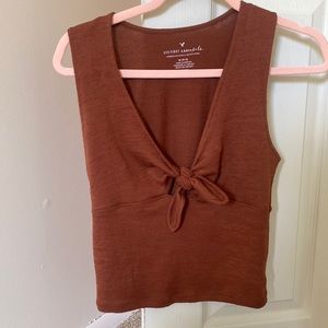 Burnt orange/maroon colored crop top.